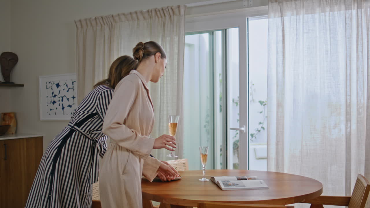 Two girls preparing lunch together at kitchen. Lady going to celebrating home
