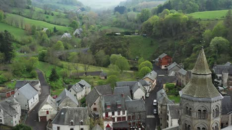 vibrant green misty valley with a dramatic romanesque church, dolly out