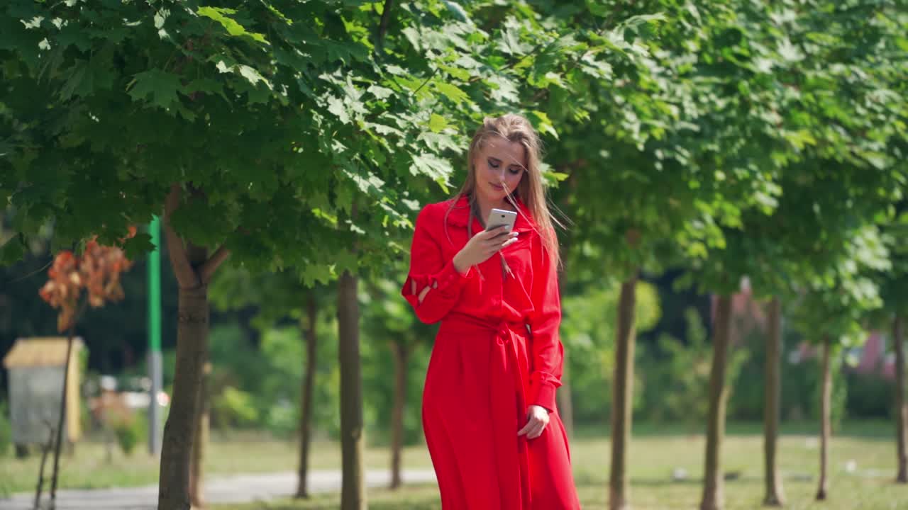 Woman using smart phone in the city. Young woman with smartphone in urban city area