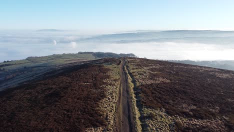 cloudy misty sunrise valley aerial rising over moorland hiking hillside muddy path lancashire