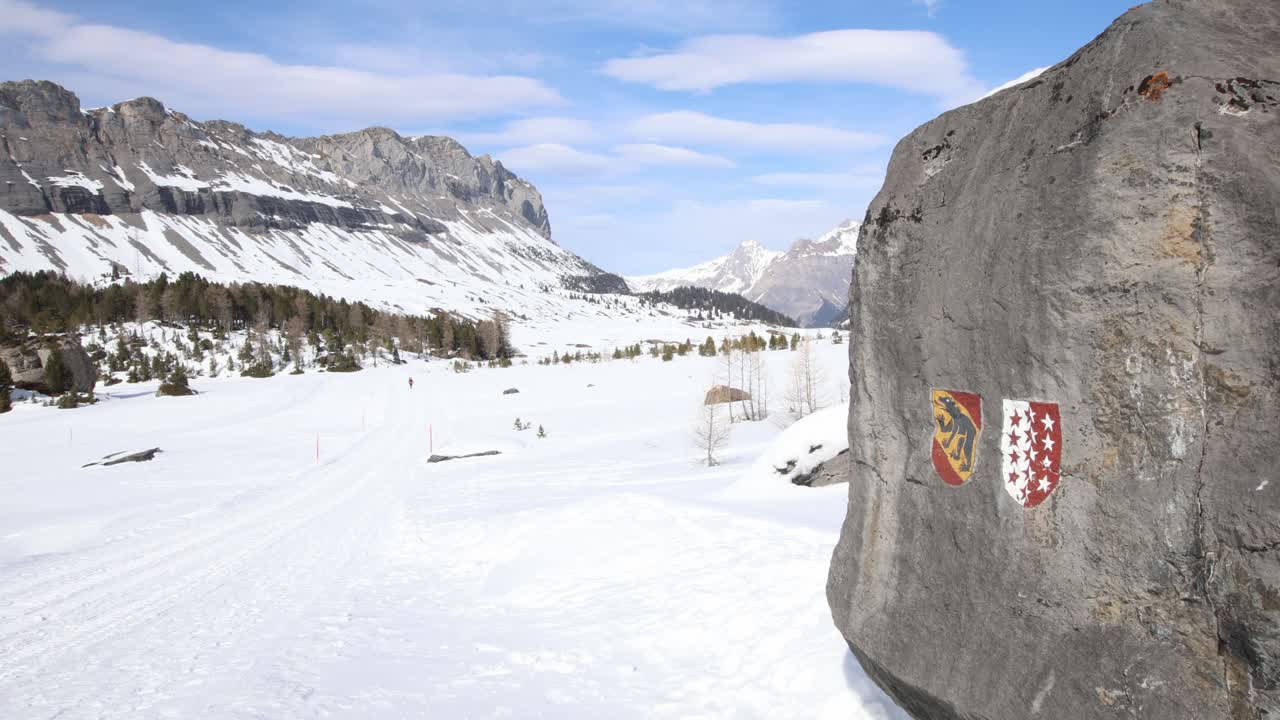 Mountain path with Bern and Valais canton flag path markers
