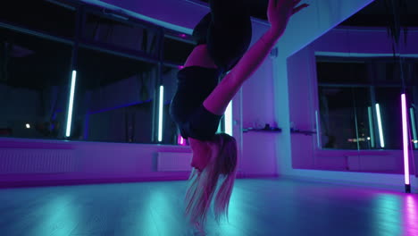 aerial yoga class woman is training alone in fitness hall using hammock for stretching