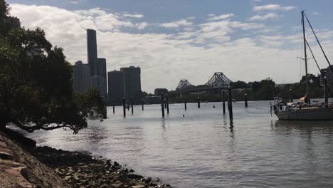 brisbane story bridge with buildings and boats on the river