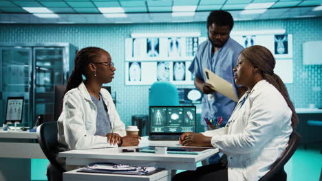 black medical staff and patient discussing diagnostic feedback and records