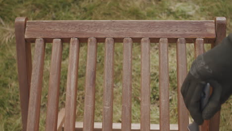 Top-shot-of-a-wooden-chair-getting-covered-with-linseed-oil-for-the-new-spring-season