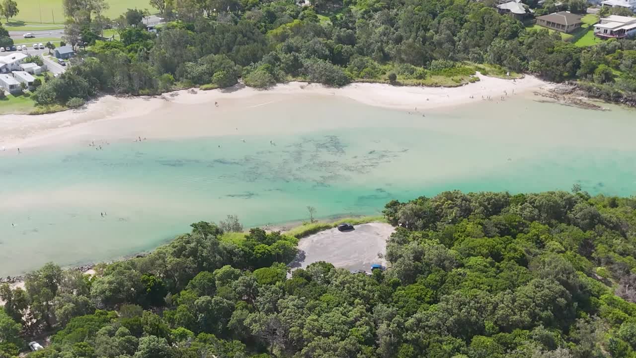 Aerial View of a Coastal Bay with Beach and People