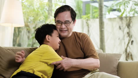 asian man and boy in the living room