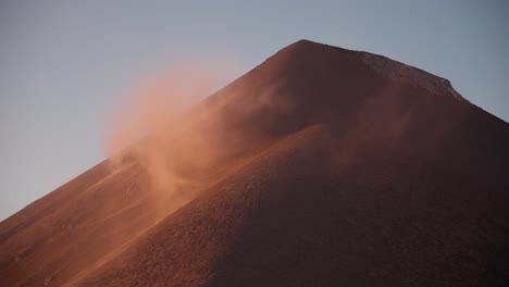 dust whirls from fuego volcano at sunrise