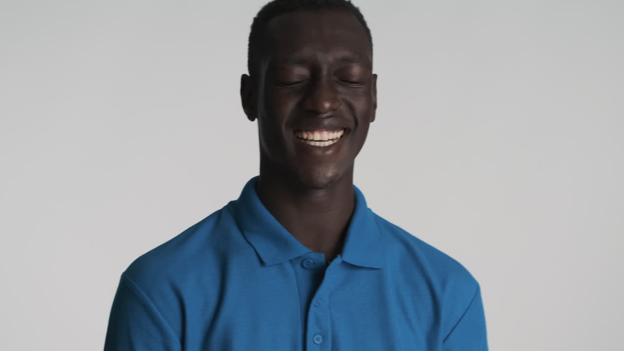 Happy African american man on grey background.
