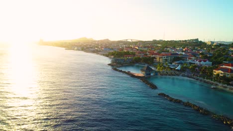 Aerial-pullback-from-coastal-lagoons-along-Pietermaai-and-Punda-in-Willemstad-Curacao-at-sunset