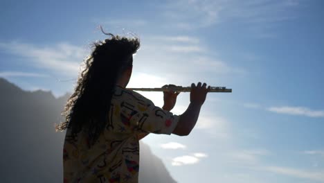 musician playing the flute on a landscape