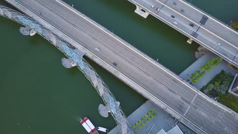 aerial of cars driving on a bridge near river