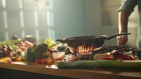 chef cooking vegetables in wok