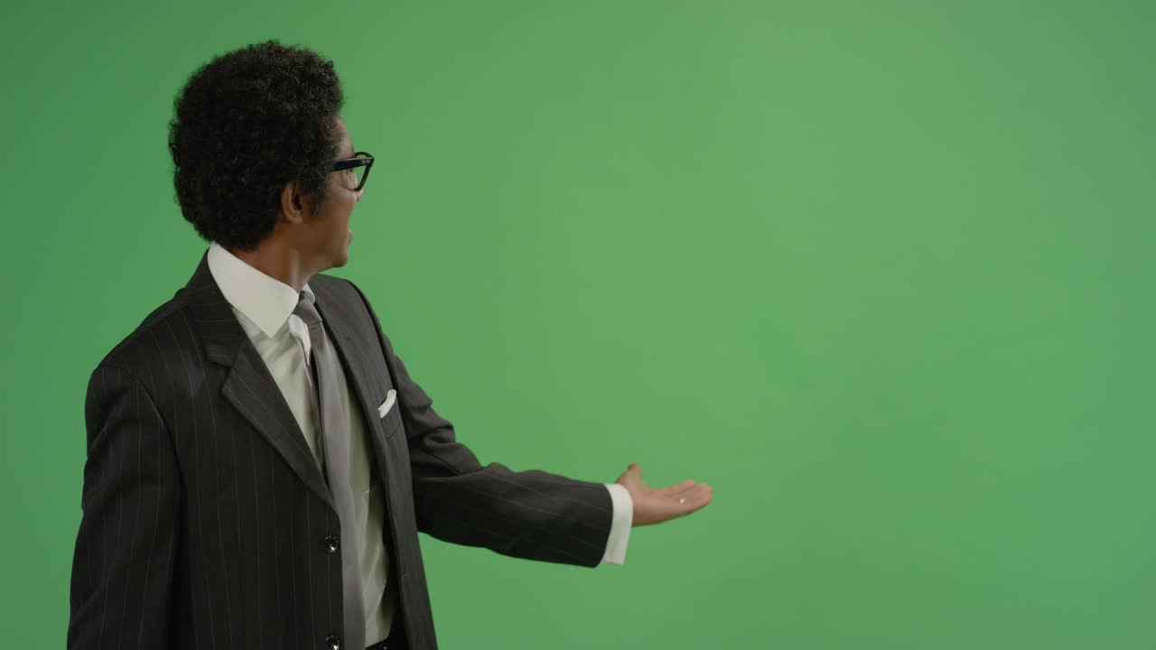 Businessman gesturing with arms on green screen