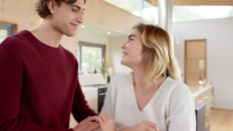couple dancing happily by cozy fireplace at home during christmas season