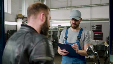 Mechanic-and-rider-talking-at-the-garage