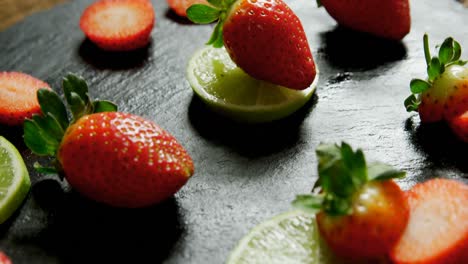 sliced strawberries and lemon on round tray 4k 4k