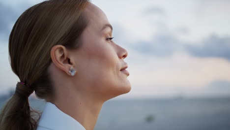 confident businesswoman enjoy evening calmness standing at gloomy sky closeup.