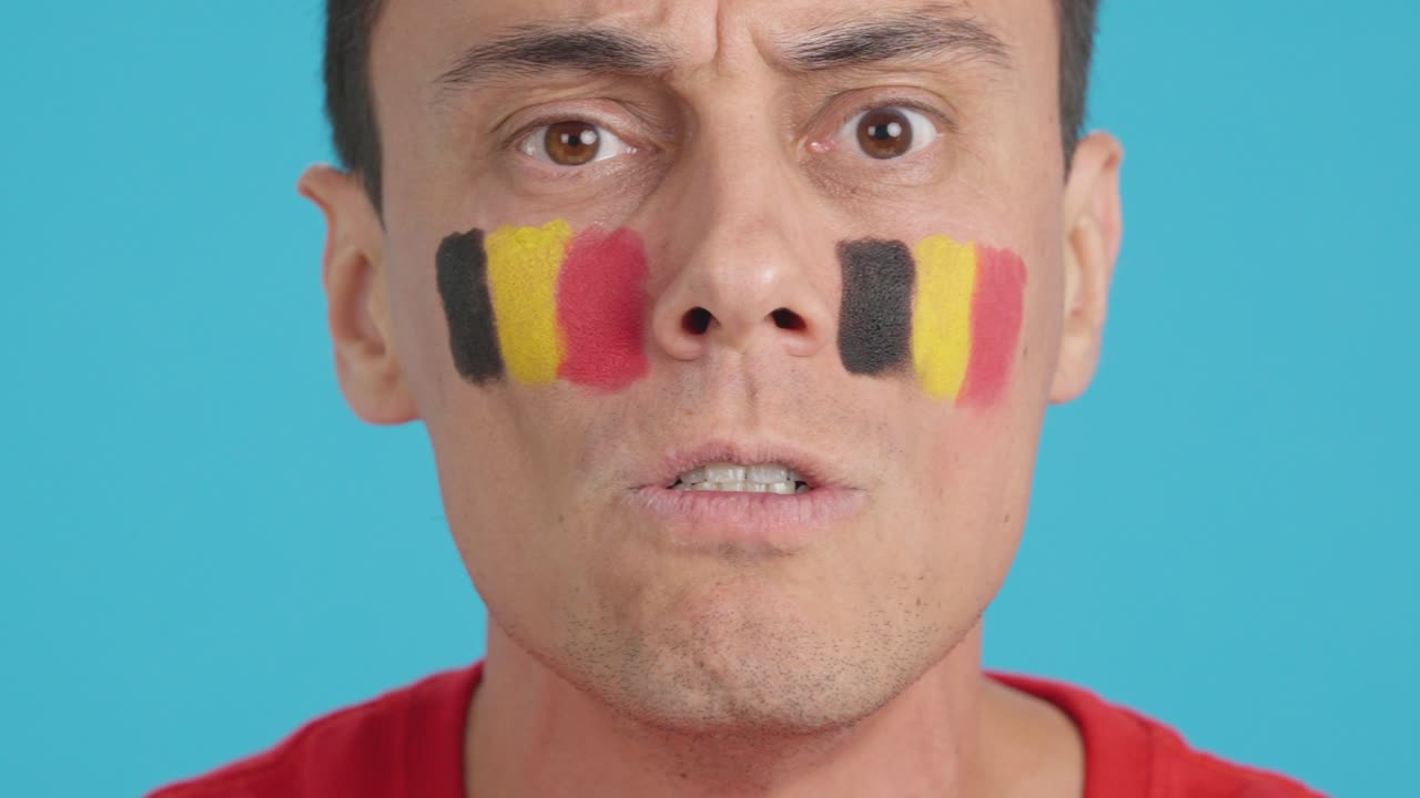 Man with belgian national flag upset with a referee