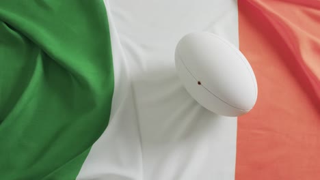 white rugby ball over flag of ireland with copy space, in slow motion