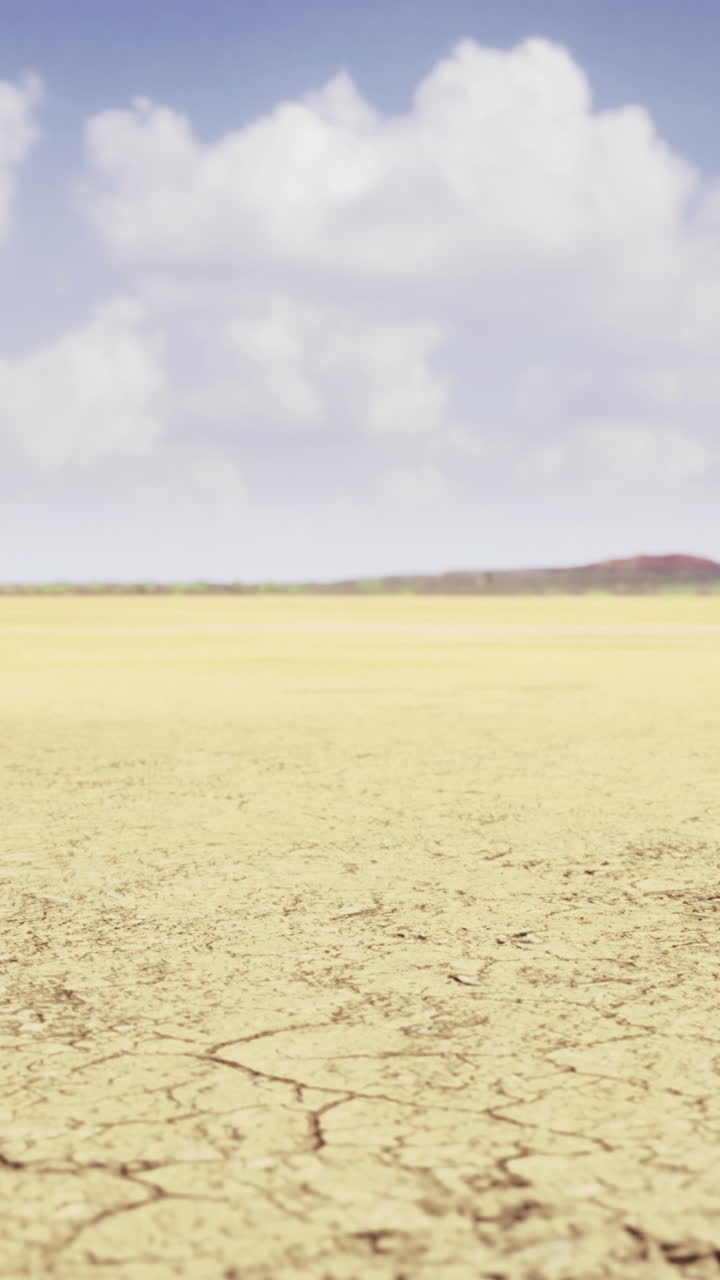 Vast arid landscape with cracked ground under a bright blue sky