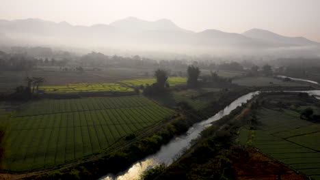 Scenic-aerial-view-flying-over-farm-fields-in-the-Thai-countryside