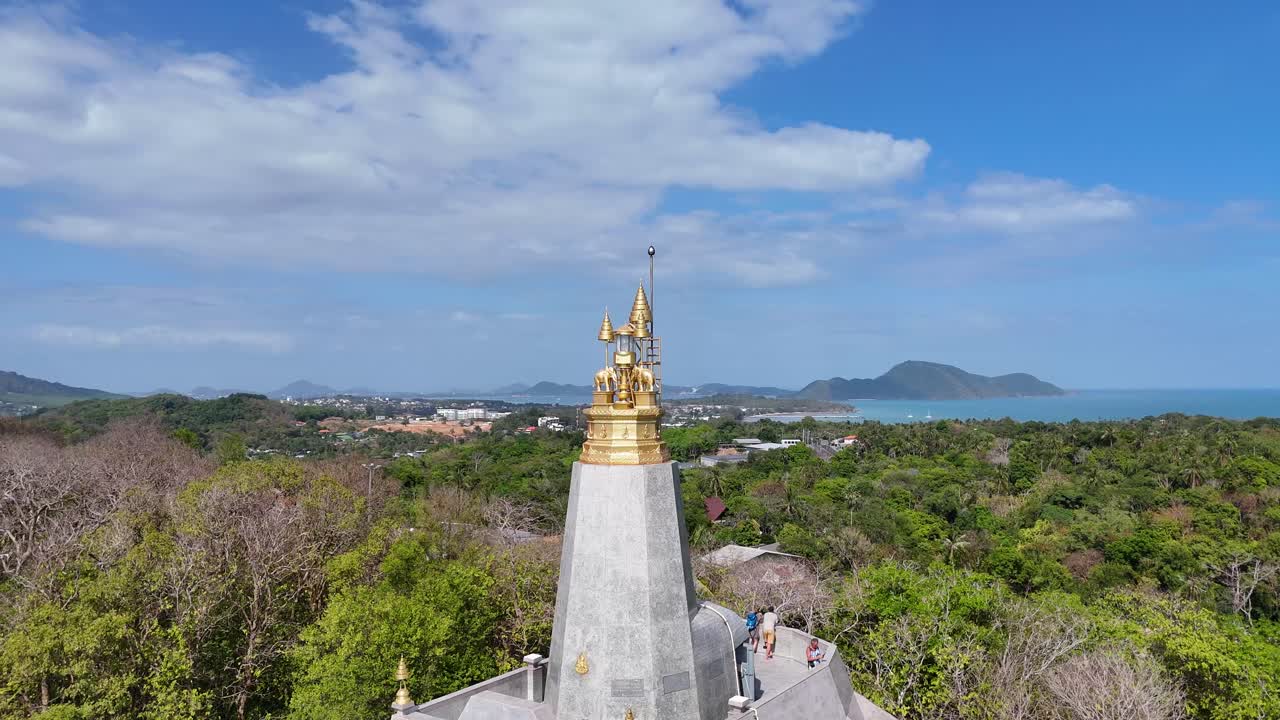 Aerial footage showcasing the lush landscape and coastline of Phuket, Thailand, with a prominent lighthouse in the foreground