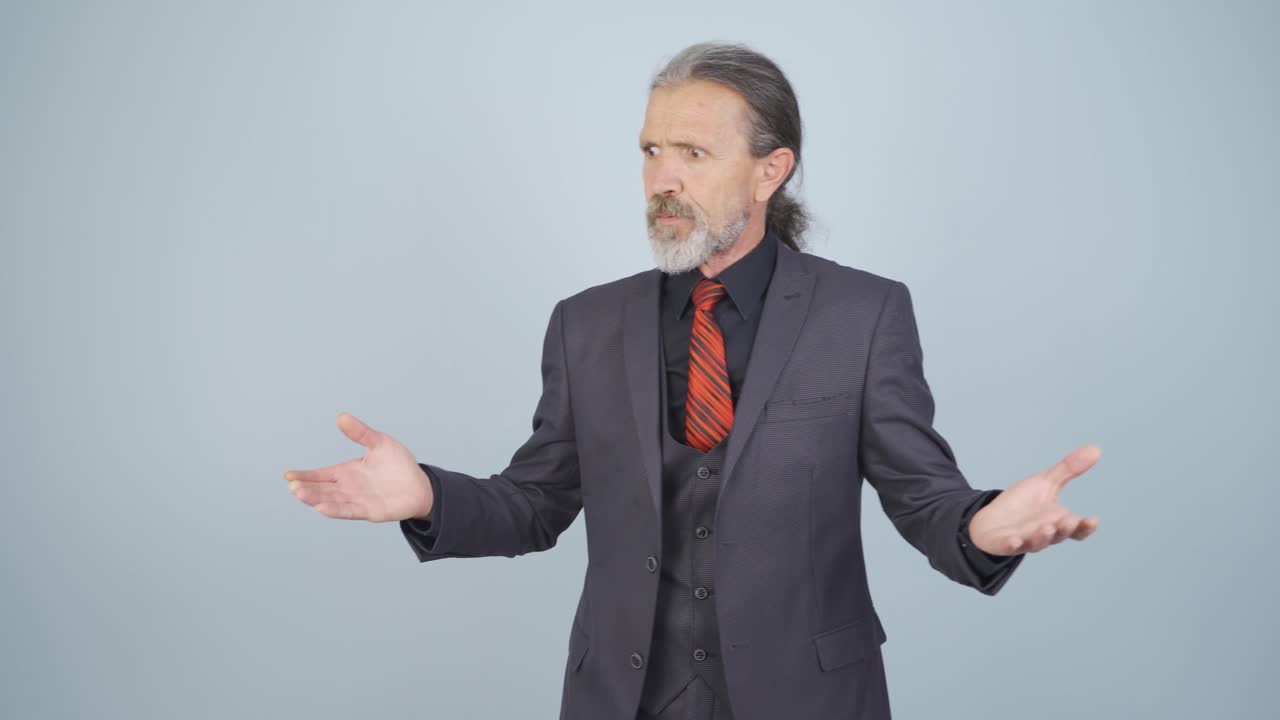 화난 사업가가 카메라를 쳐다보고 있습니다.