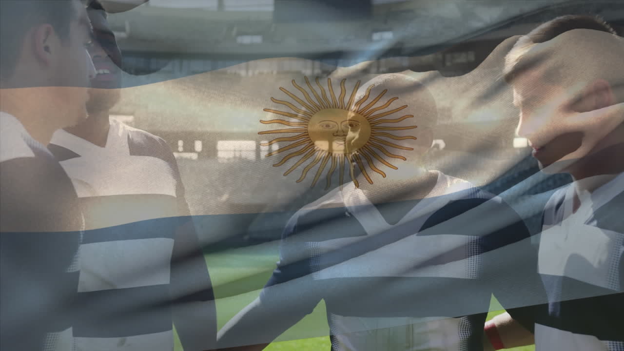 Animation of flag of argentina waving over diverse male players discussing before match at stadium