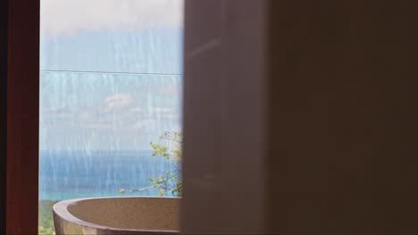 luxury freestanding stone bathtub in bathroom overlooking the ocean