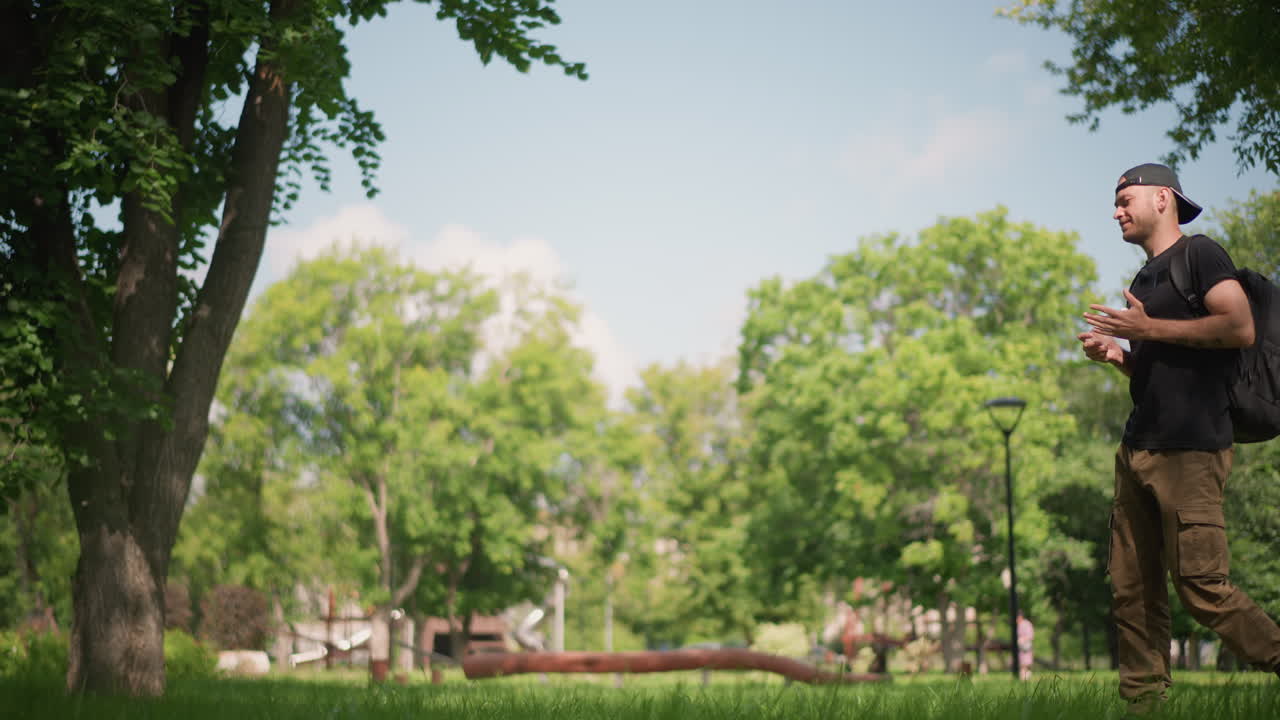 Male Hiker Relaxing In Nature, Calm Outdoor Wanderer Taking Break Among Green Surroundings, Peaceful Male Adventurer Exploring Natural Scenery And Pausing Quietly In Vibrant Outdoor Environment
