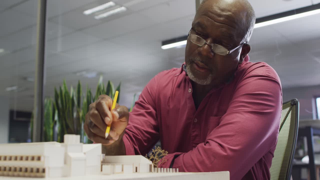 Video of focused african american male designer working on project