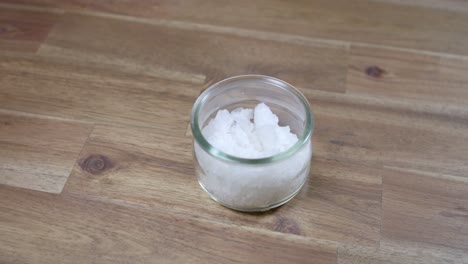 panning shot of coarse sea salt sitting in a jar