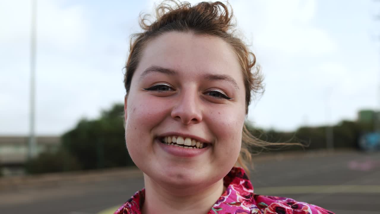 Young woman smiling on camera