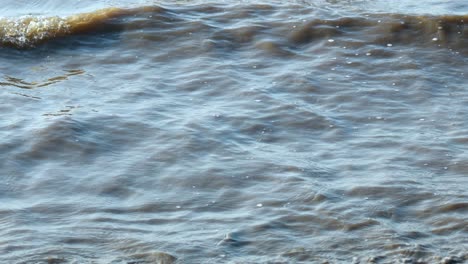 waves and a small fishing boat