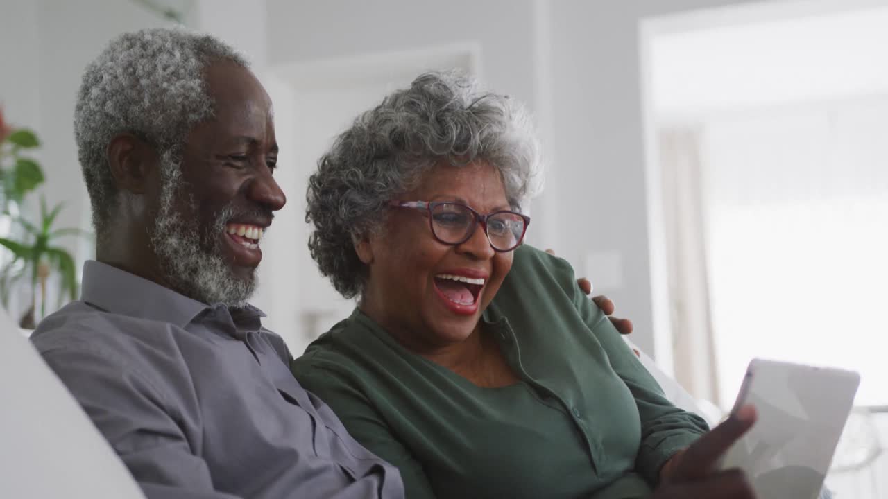 A senior African american couple laughing at home. Social distancing in quarantine