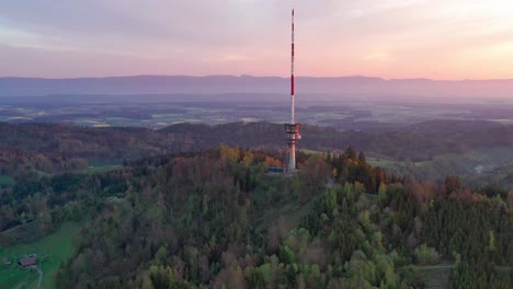 aerial drone view from above the bantiger tv tower on a gorgeous morning with dramatic sunrise colors and lush mountain views