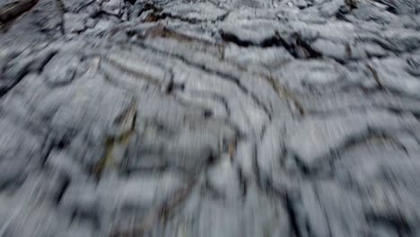 Dynamic-flight-over-a-cooling-field-of-black-lava-revealing-a-smoking-volcano-in-Iceland