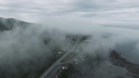 Clouds-Covering-The-Village-And-The-Road-By-The-Chic-Choc-Mountains-In-Gaspe-Peninsula,-Quebec-Canada-Through-Foggy-Morning