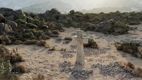 cruz de piedra en el desierto