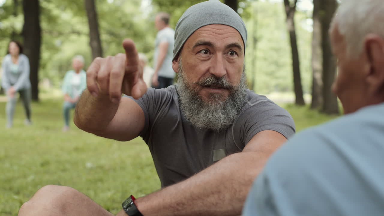 Older men exercising and discussing fitness in a park