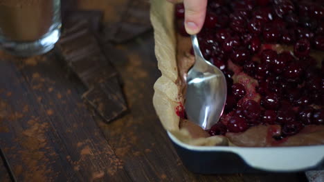 mixing cherries in dough for chocolate cake. cooking chocolate brownie