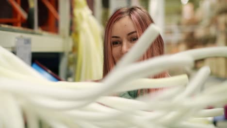 woman playing with foam strips in hardware store