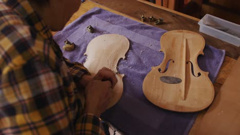 female luthier at work in her workshop