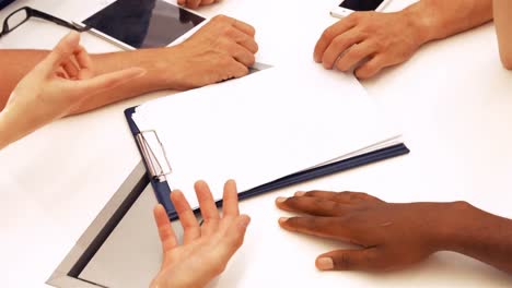 male and female business executives interacting with each other in a meeting