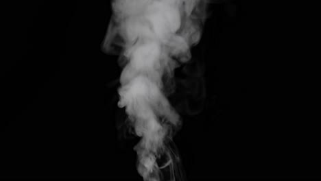 water vapor. white jet of vapour steam under pressure on black background, micro drops of hot water are sprayed in air, dry smoke fog