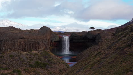 aerial footage showcasing salto del agrio, a breathtaking waterfall in neuquén, argentina, surrounded by rugged volcanic cliffs
