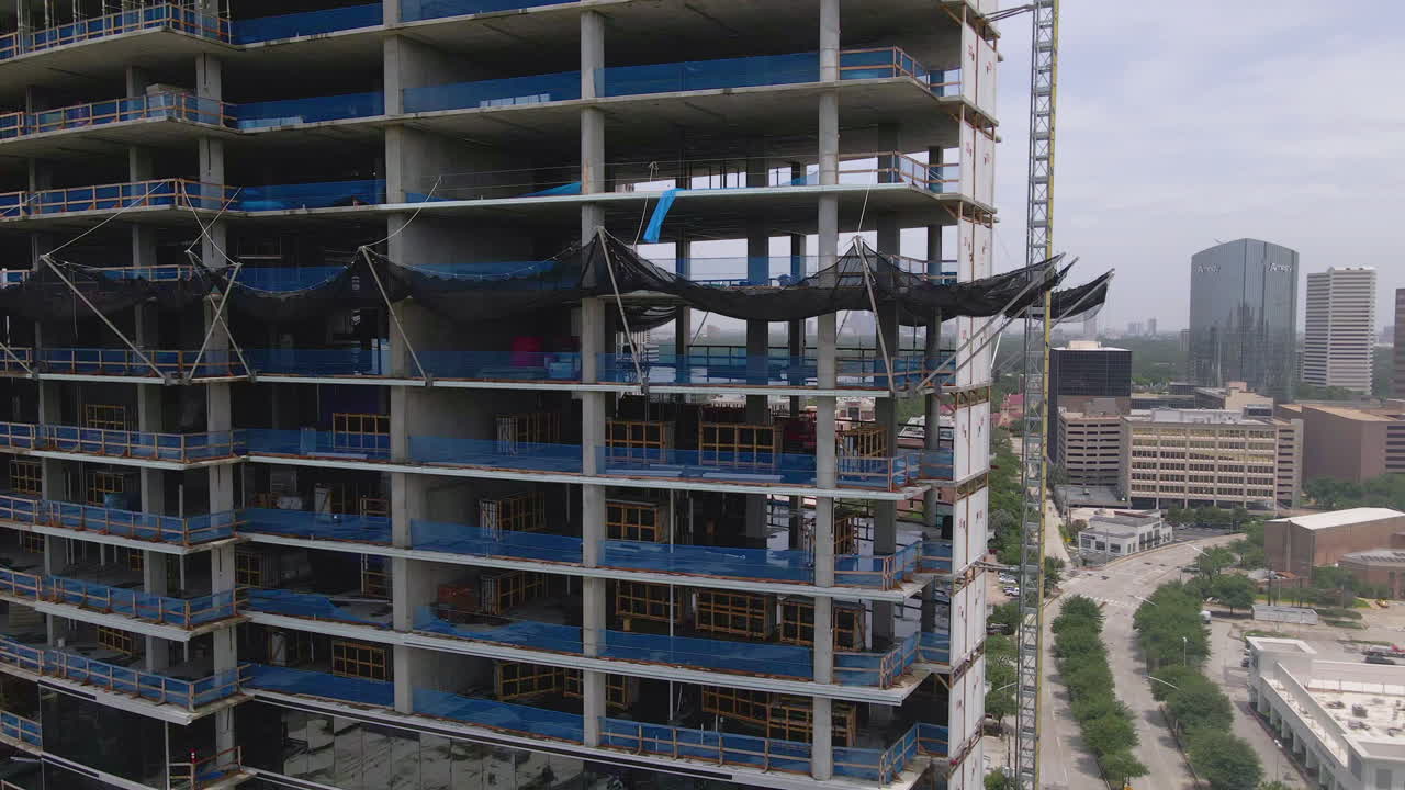 Side aerial view of large building construction in downtown Houston, Texas, USA