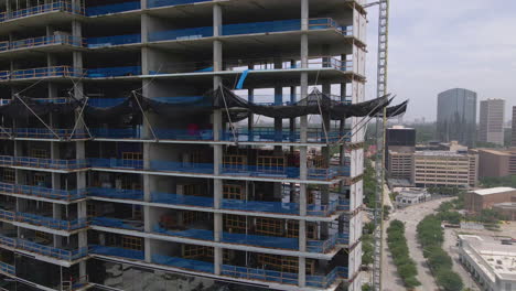 side aerial view of large building construction in downtown houston, texas, usa