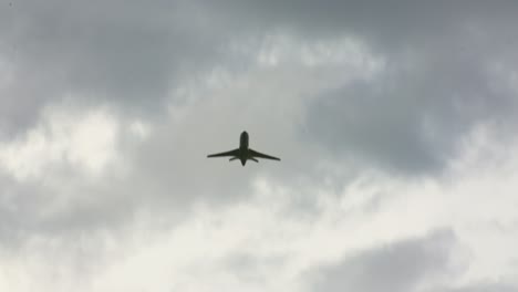 airplane flying straight overhead on a cloudy day handheld calgary alberta canada